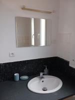 a bathroom with a sink and a mirror at La Casa in Saint-Brieuc