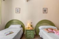 A bed or beds in a room at Apartamento Arenal 3 - PlusHolidays