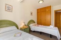 A bed or beds in a room at Apartamento Arenal 3 - PlusHolidays