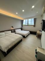 a hotel room with two beds and a flat screen tv at Dongshan River Resort Farm in Wujie