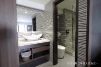 a bathroom with a sink and a toilet at Talmud Hotel Yizhong in Taichung