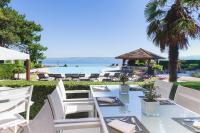 a dining table and chairs with a view of the ocean at Hôtel Royal in Évian-les-Bains