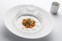 a white plate with a dish of food on a table at Hôtel Royal in Évian-les-Bains