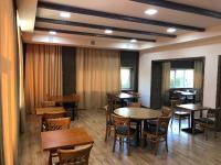a dining room with wooden tables and chairs at Vanadzor Armenia Health Resort & Hotel in Vanadzor