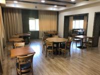 a dining room with wooden tables and chairs at Vanadzor Armenia Health Resort & Hotel in Vanadzor
