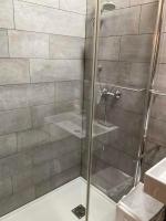 a shower with a glass door in a bathroom at Hotelski in Verbier