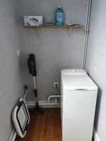 a small kitchen with a white refrigerator and a phone at Cosy Billy - Appartement de charme in Billy