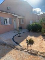 a house with a driveway in front of it at Charmante villa équipée, piscine in Le Soler