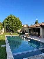 a swimming pool in the yard of a house at MAS MILLÉSIME - Chambre double - petit déjeuner - piscine - Mas du XVIIIème siècle proche Saint-Rémy-de-Provence in Mas blanc des Alpilles