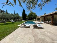 a patio with lounge chairs and a swimming pool at MAS MILLÉSIME - Chambre double - petit déjeuner - piscine - Mas du XVIIIème siècle proche Saint-Rémy-de-Provence in Mas blanc des Alpilles