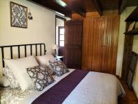 a bedroom with a large bed with pillows on it at Maison en Cerdagne avec belle vue in Enveitg