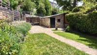 a garden with a stone building in a yard at Maison en Cerdagne avec belle vue in Enveitg