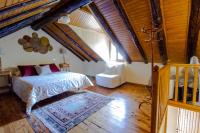 a bedroom with a bed and a wooden floor at Maison en Cerdagne avec belle vue in Enveitg