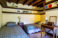 a bedroom with two beds and a wooden table at Maison en Cerdagne avec belle vue in Enveitg