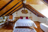 a bedroom with a large bed in a attic at Maison en Cerdagne avec belle vue in Enveitg