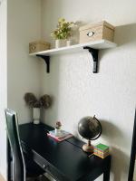 a black desk with a shelf on a wall at Chambre privée avec petit salon extérieur in Bordeaux