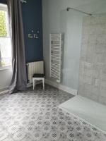 a bathroom with a shower with a bench and a table at Cosy Billy - Appartement de charme in Billy