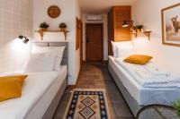 two beds in a small room with a door at Panorama Górska Wisła Resort & SPA in Wisła