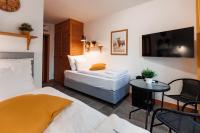 a hotel room with two beds and a table at Panorama Górska Wisła Resort & SPA in Wisła