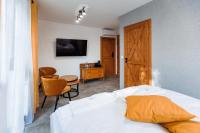 a bedroom with a bed and a desk and a chair at Panorama Górska Wisła Resort & SPA in Wisła