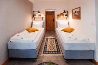 two twin beds in a room with a hallway at Panorama Górska Wisła Resort & SPA in Wisła