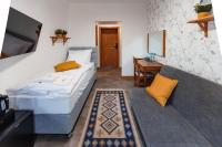 a bedroom with a bed and a couch and a desk at Panorama Górska Wisła Resort & SPA in Wisła