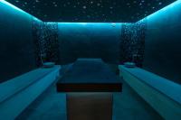 a blue room with a table in the middle at Panorama Górska Wisła Resort & SPA in Wisła