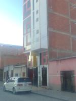 a car parked in front of a building at Hostal Sin fronteras in Uyuni
