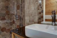 a bathroom with a white sink and a shower at Vlasinsko jezero VILA BEST in Surdulica