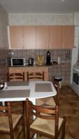 a kitchen with a table and some chairs and a counter at gite à la campagne in Plombières-les-Bains