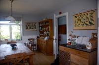 a kitchen with a wooden table and a dining room at Le Buisson B&amp;B in Gouvy