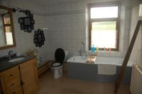 a bathroom with a tub and a toilet and a sink at Le Buisson B&amp;B in Gouvy