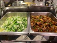 two metal trays of food with broccoli and meat at Link World Hotel in Taipei