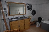 a bathroom with two sinks and a toilet and a mirror at Le Buisson B&amp;B in Gouvy