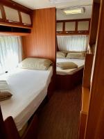 Posteľ alebo postele v izbe v ubytovaní PS-Caravaning auf Union Lido - Wohnwagenvermietung