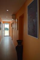 a hallway with orange walls and a vase on the wall at VILLA RASOA chambre LIBELLULE in Cap d&#39;Agde