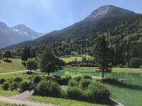 a view of a lake with mountains in the background at Chaleureux studio plein sud en Tarentaise ! in Bozel