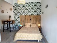 a bedroom with a bed and a large wall at Logement zen love, 5 mn de la plage in Toulon