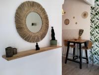 a mirror on a wall next to a table at Logement zen love, 5 mn de la plage in Toulon