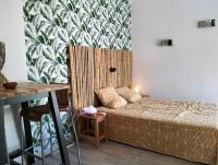 a small bedroom with a bed and a table at Logement zen love, 5 mn de la plage in Toulon