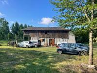 a house with two cars parked in front of it at L&#39;écrin - Chambres d&#39;hôtes au calme et au vert 