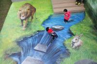 a child standing next to a painting of a lion and a river at Minsuku B&amp;B in Taitung City