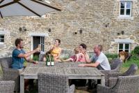 a group of people sitting around a table with wine glasses at Le gîte de Froidefontaine in Havelange