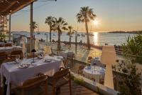 a restaurant with tables and a view of the ocean at Hotel & Spa Blau Parc in San Antonio