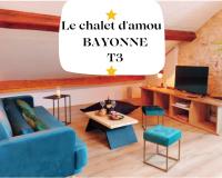 a living room with a blue couch and a table at Le Chalet d&#39;Amou in Bayonne