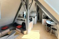 an attic room with a table and a desk at Studio Design Sous Toits IntraMuros Vue Cathédrale in Vannes