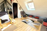 a living room with two chairs and a window at Studio Design Sous Toits IntraMuros Vue Cathédrale in Vannes