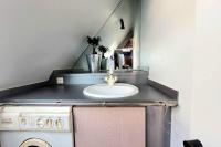 a bathroom with a sink and a washing machine at Studio Design Sous Toits IntraMuros Vue Cathédrale in Vannes