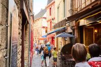 a group of people walking down a narrow street at Studio Design Sous Toits IntraMuros Vue Cathédrale in Vannes