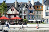 a group of people walking and a man riding a bike at Studio Design Sous Toits IntraMuros Vue Cathédrale in Vannes